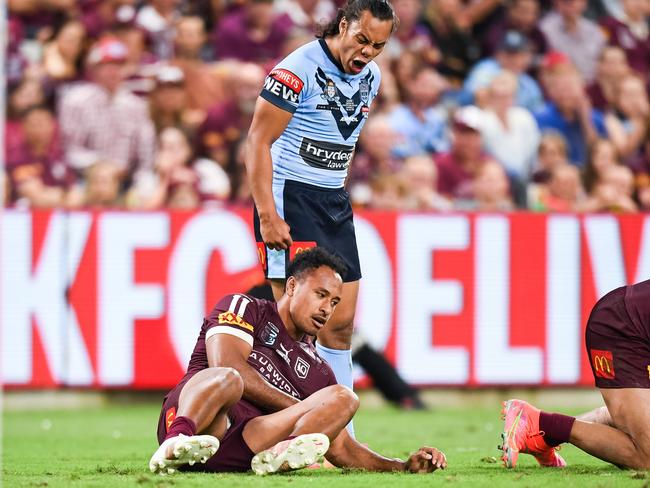 Blues five-eighth Jarome Luai stands over Maroons forward Felise Kaufusi