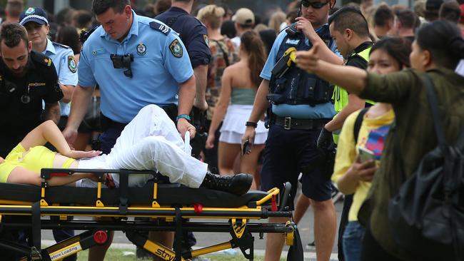 A girl is treated by paramedics inside the festival. Picture: Damian Shaw