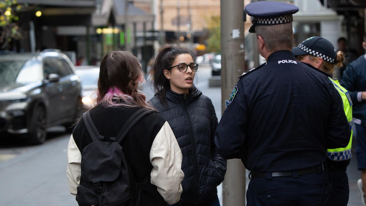 Superintendent Scott Denny speaks with Virginia Blanco on Bank St on Friday after the cafe worker told how she was threatened. Picture: Brett Hartwig