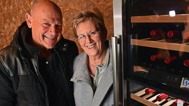 John Davison and wife Leanne with the fridge containing a full set of Grange they successfully bid on at auction. Picture: Tom Huntley