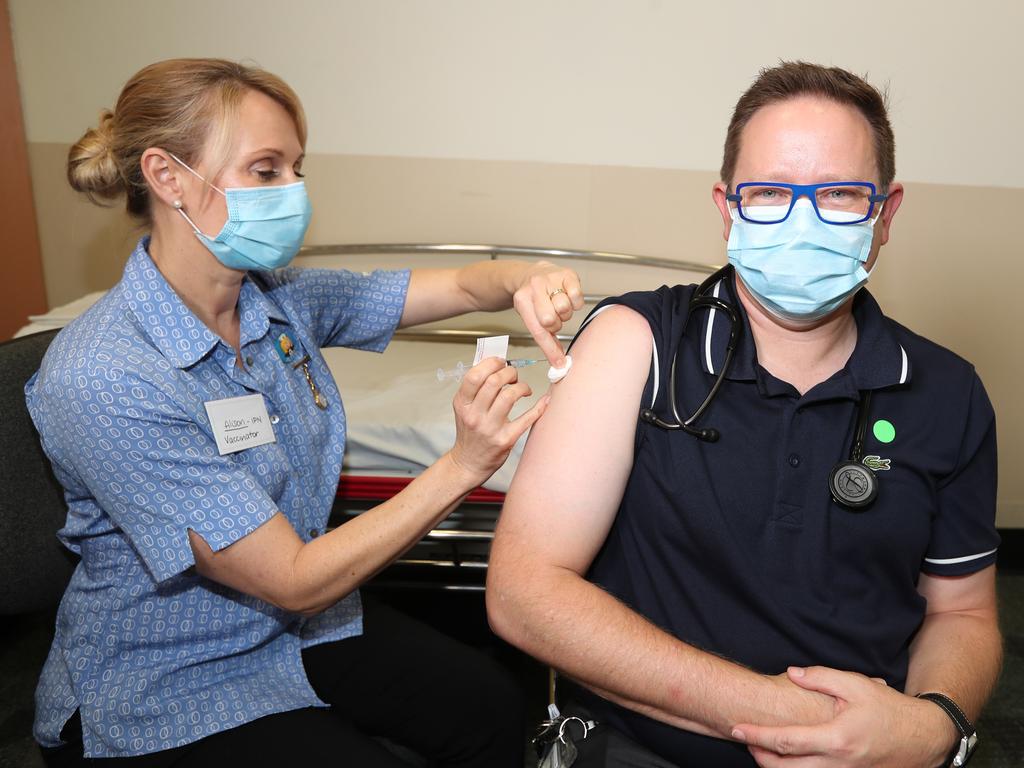 Nurse Alison Clancy administers the Covid vaccine to Associate Professor Paul Griffin at the Mater Hospital in March, 2021. Picture: Annette Dew