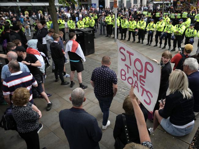 Police form a divide between people taking part in an anti-racism counter protest and far-right activists protesting at Piccadilly Gardens on August 3. Picture: Getty Images