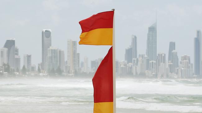 Red and yellow swimming flags with a Gold Coast skyline as a backdrop. Picture: Brendan Radke.