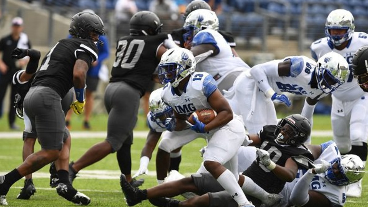 Bishop Sycamore, in black, faces IMG Academy in a high school football game that was aired on ESPN.