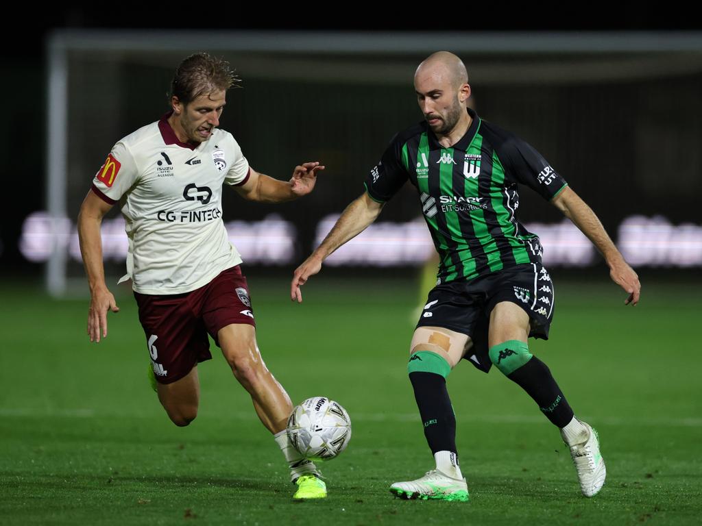 Western United’s Angus Thurgate is challenged by Adelaide United’s Stefan Mauk. Picture: Getty Images