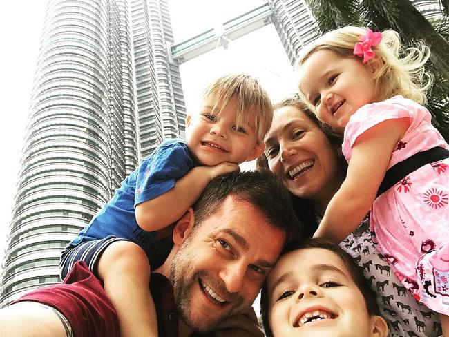 David Campbell with his family in Kuala Lumpur, wherein the red suit was born. Source: Instagram