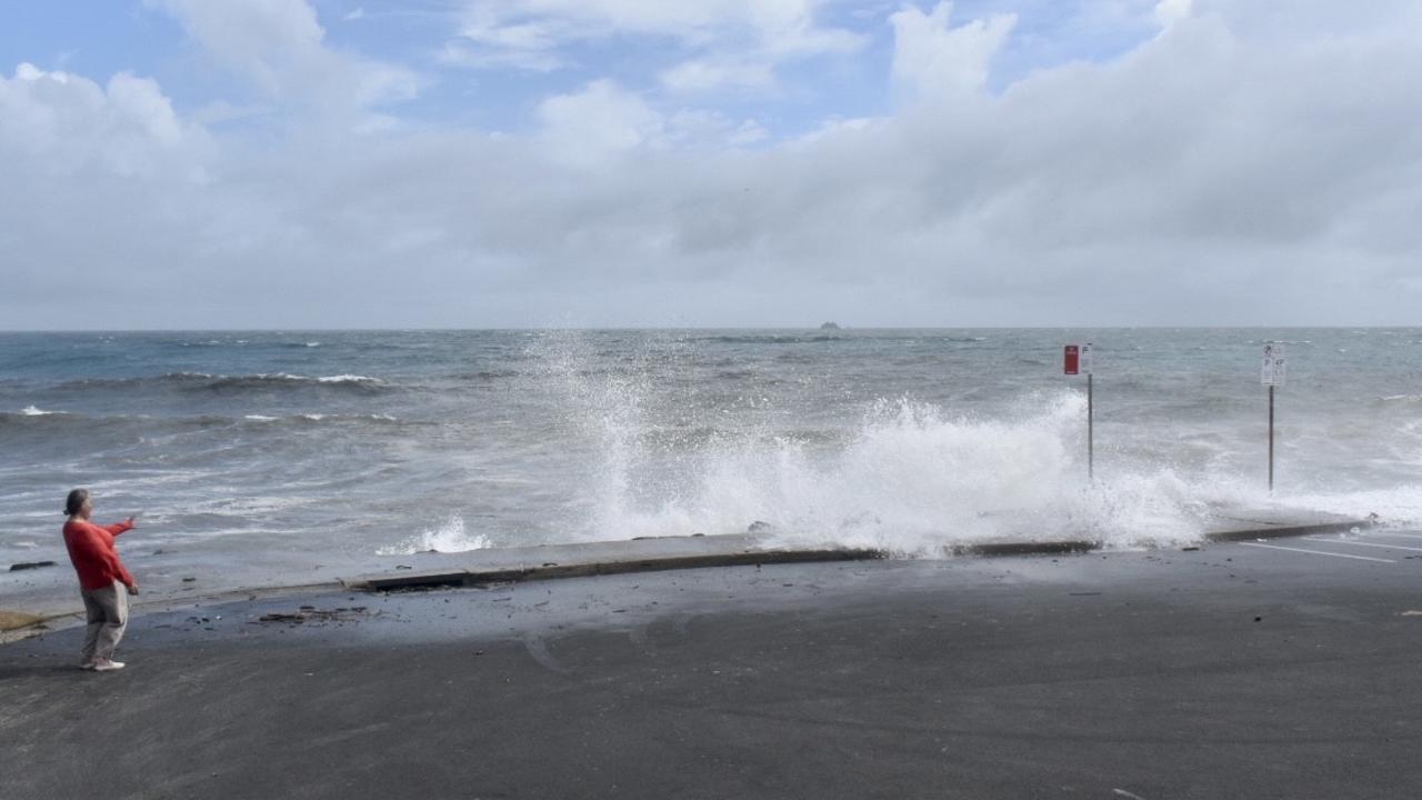 Main Beach in Byron Bay remained closed but many visitors and residents decided to check out the high tide on Tuesday morning.