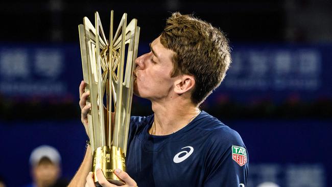 Alex de Minaur kisses the trophy after victory in the men's singles final at the Zhuhai Championships tennis tournament in China in September. Picture: STR / AFP