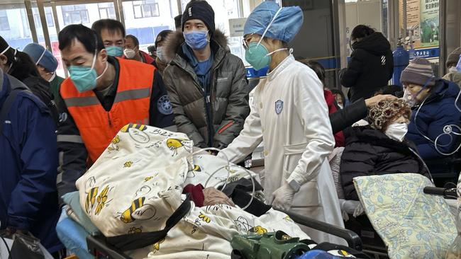 BEIJING, CHINA - JANUARY 02: (CHINA OUT) A patient on oxygen is wheeled on a gurney into a busy emergency room at a hospital on January 2, 2023 in Beijing, China. China has seen a surge in COVID-19 cases since the government lifted its strict zero tolerance measures to contain the virus earlier this month and hospitals in many cities with severe COVID-19 outbreaks have been overwhelmed by the increase in patients. (Photo by Getty Images)