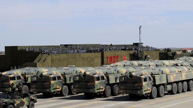 Chinese military vehicles carrying missiles for both nuclear and conventional strikes are driven past the VIP stage. Picture: Zha Chunming/Xinhua via AP