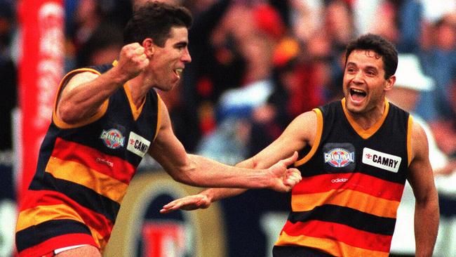 Darren Jarman celebrates one of his record five final quarter goals with Troy Bond.