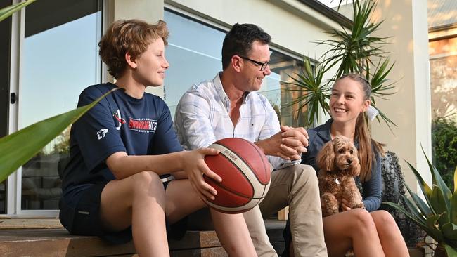 Catapult Wealth director Tony Catt at home with his daughter Maegan, son Angus, and Molly the dog Picture: Keryn Stevens