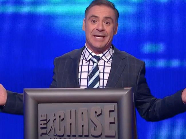 Screen grab of Andrew O'keefe  on The Chase Episode 59 - Wed 8 Jul of 7plus, wedding band on, https://7plus.com.au/the-chase-australia