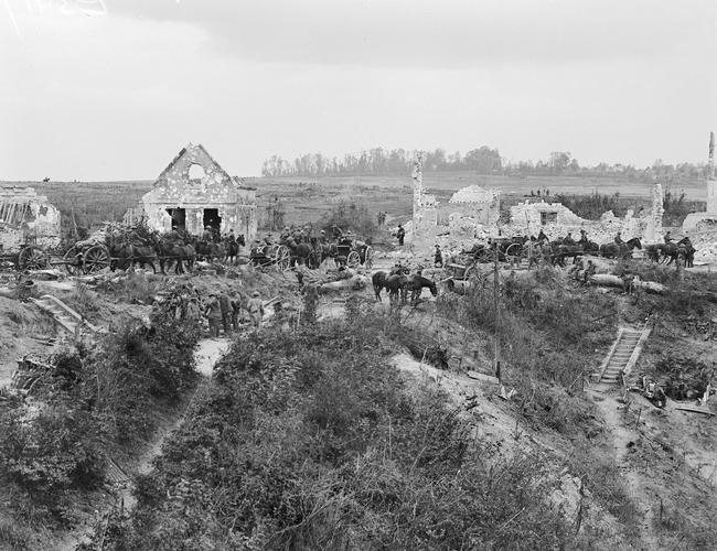 The Australian Field Artillery 7th Brigade passes through the wrecked village of Riqueval. Picture: Courtesy Australian War Memorial