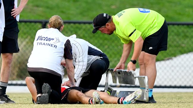 James Charbel of Watsonia receives medical attention after sustaining an injury which stopped play during the round four NFNL Division 2 MC Labour Seniors match between Watsonia and Panton Hill at Binnak Park, on April 27, 2024, in Melbourne, Australia. (Photo by Josh Chadwick)