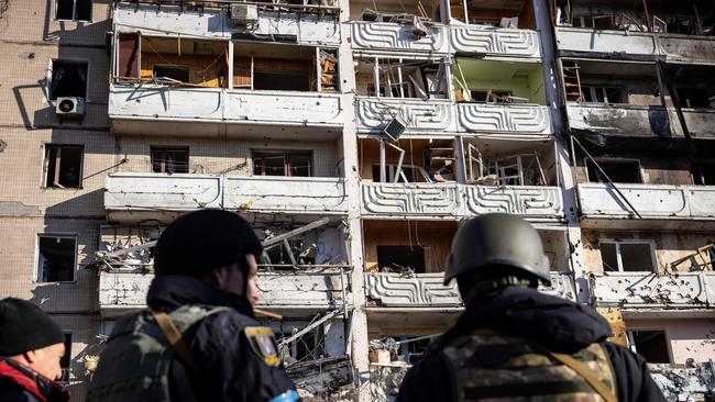 Ukraine militaries stand by the rubble of a destroyed apartment building in Kyiv. Picture: AFP