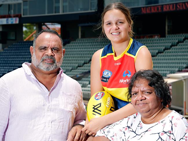 Danielle Ponter who has been drafted into the Adelaide Crow's AFLW team with Michael Long and mum Susie Long at TIO Stadium.