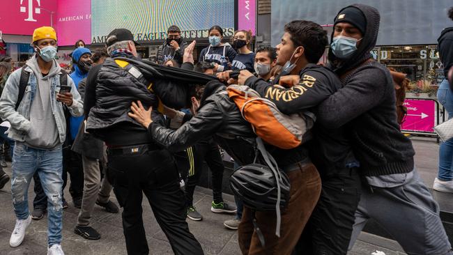 Trump supporters and opponents clash on New York’s Times Square on Monday. Facebook is preparing a ‘tool kit’ to combat election-related violence. Picture: AFP