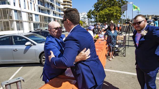 Bridegroom Jake Jones hugs his dad Mark at the border barricades. Picture: NIGEL HALLETT