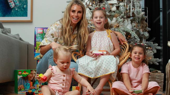 Candice Warner with her children, Isla, 17 months. Ivy, 6, and Indi, 4, playing with LEGO, at home, in Maroubra. Picture: Justin Lloyd.