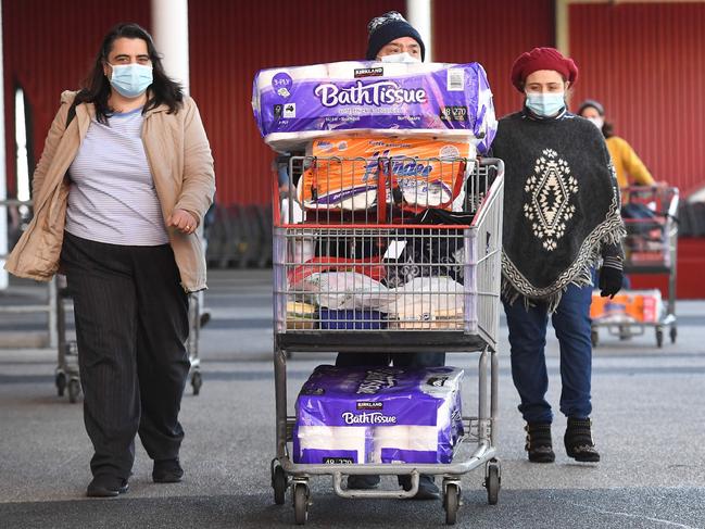 Shoppers load up trolleys as they prepare to enter lockdown. Picture: AFP