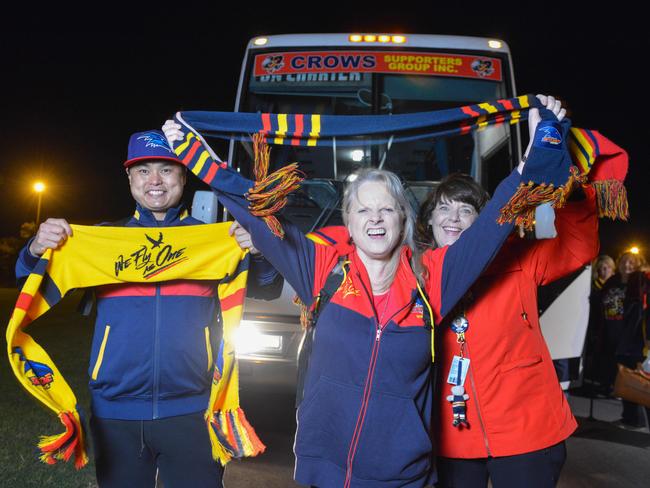 John Lam, Linda Cox and Jacquie Radan, whose daughter Talia Radand plays for the Crows women's team, join two busloads of Crows fans heading off to Melbourne on Thursday night. Picture: Brenton Edwards