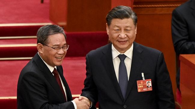 Chinese leader Xi Jinping congratulates new Premier Li at the National People’s Congress last year. Picture: AFP