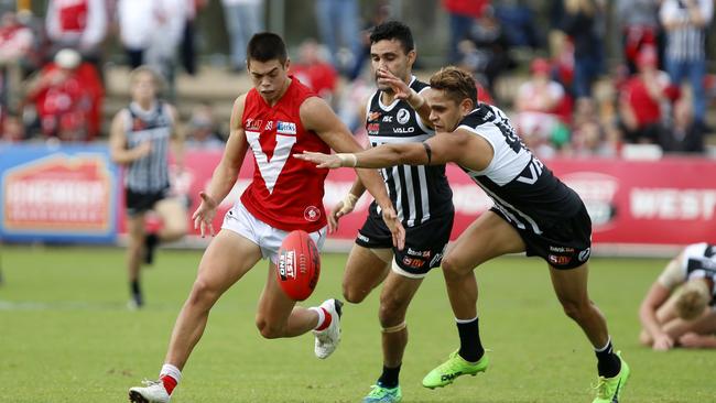 North Adelaide debutant Jared Deep is chased by Port Adelaide AFL-listed players Dom Barry and Lindsay Thomas in their SANFL clash on Saturday. Picture Deb Curtis