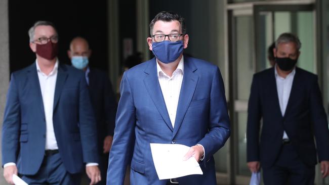 Victorian Premier Daniel Andrews, flanked by Health Minister Martin Foley, left, and Chief Health Officer Brett Sutton, right. Picture: David Crosling