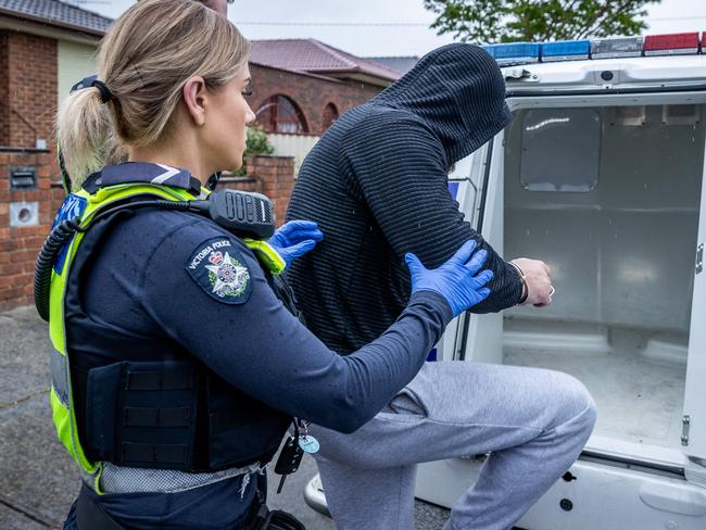 Police from Dandenong conduct firearms prohibitions order checks on youths (above 18 years old) who are believed to be members of youth gangs or have links to youth gangs. Officers take a man into police custody. Picture: Jake Nowakowski