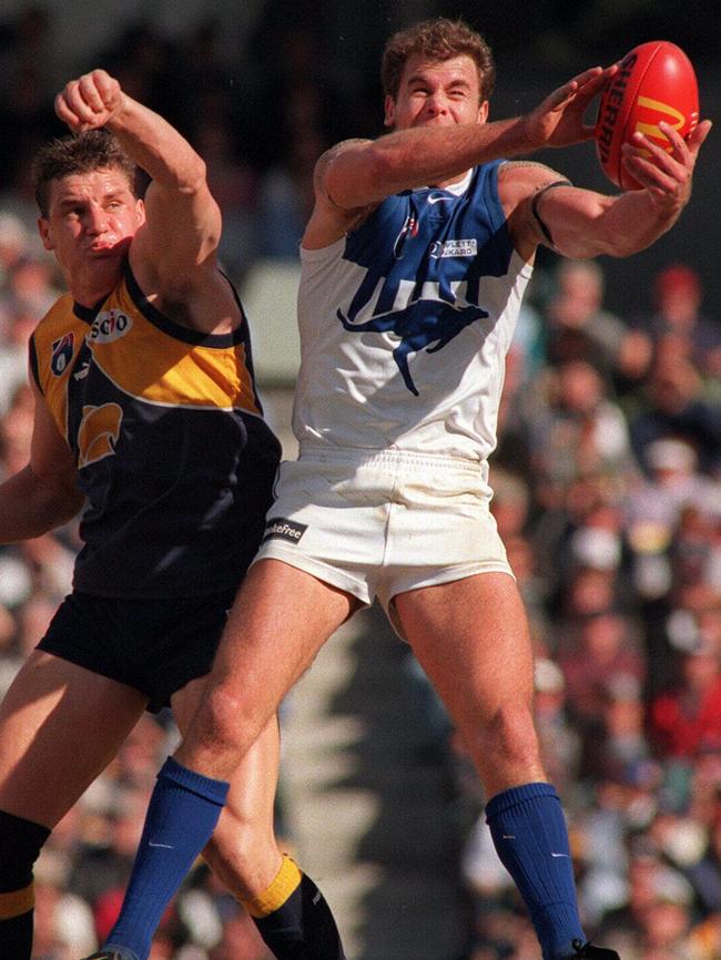 Glen Jakovich and Wayne Carey stage one of their epic duels in the 1990s. Picture: Ian Cugley