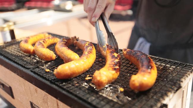 Chef Ben Milbourne cooks up some of Vermey’s fine sausages. Picture: MATHEW FARRELL