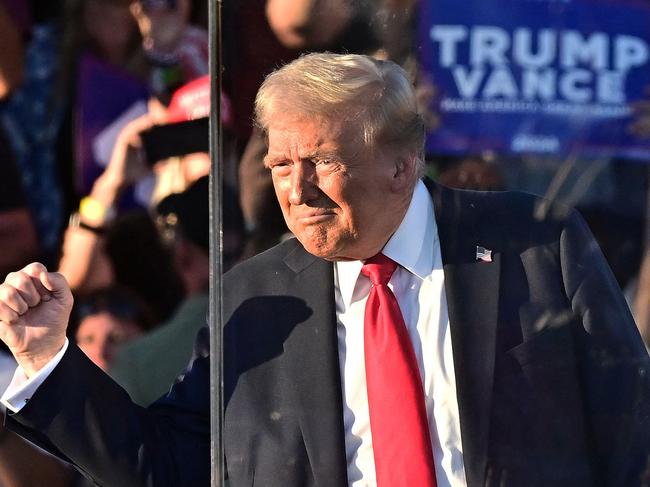 TOPSHOT - Former US President and Republican presidential candidate Donald Trump gestures as she arrives for a campaign rally at Calhoun Ranch in Coachella, California, on October 12, 2024. (Photo by Frederic J. BROWN / AFP)