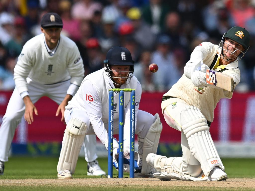 David Warner hits a boundary off the bowling of England's Moeen Ali as England's Jonny Bairstow (C) keeps wicket on day three of the fourth Test. Picture: AFP