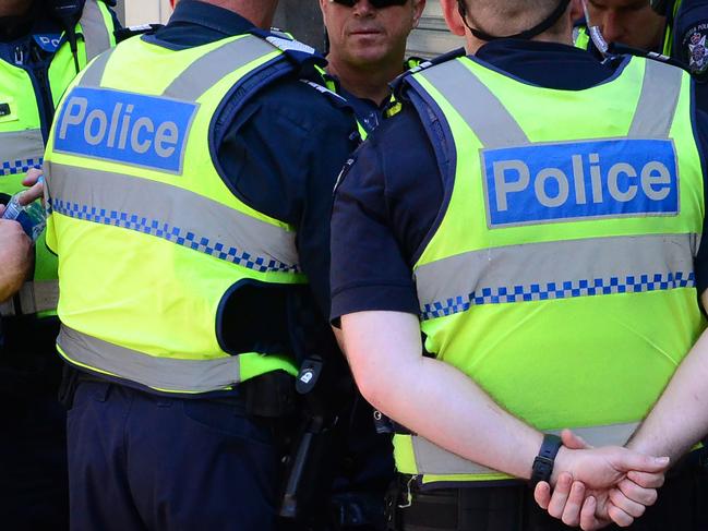 Police officers are seen as one of five men charged over an alleged terror plot is taken by a police vehicle into the Magistrates Court in Melbourne, Friday, Dec. 23, 2016. Three men charged over an alleged terror plot targeting Melbourne landmarks on Christmas Day have faced court. They were arrested in relation to an alleged Islamic State-inspired plot targeting Flinders Street Station, Federation Square and St Paul's Cathedral. (AAP Image/Mal Fairclough) NO ARCHIVING