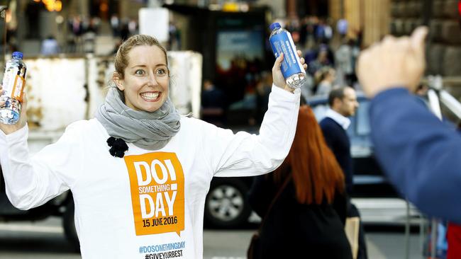 Do Something Day Angel Kimberly Morey hands out water bottles last year. Picture: John Appleyard