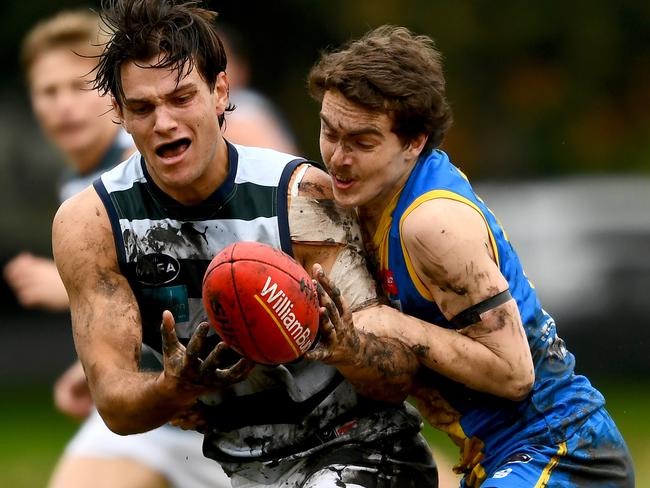 Lachlan Dunell of Old Geelong tries to get rid of the ball. Picture: Josh Chadwick