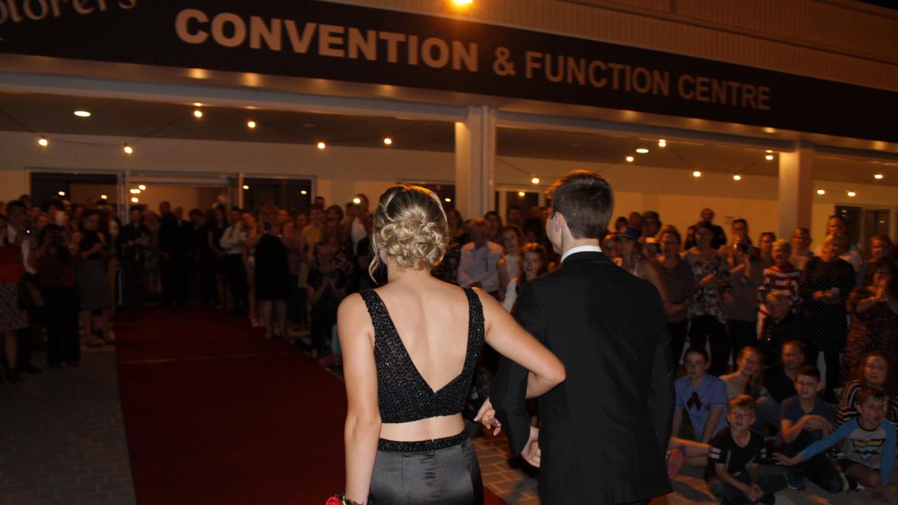 Jemma Hawker and Gerard Treasure make their entrance at the St John's Formal in Roma.