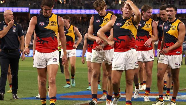 Shattered Crows players, with coach Matthew Nicks (left), trudge from Perth’s Optus Stadium after their loss to Fremantle on Good Friday. Picture: Paul Kane/Getty Images