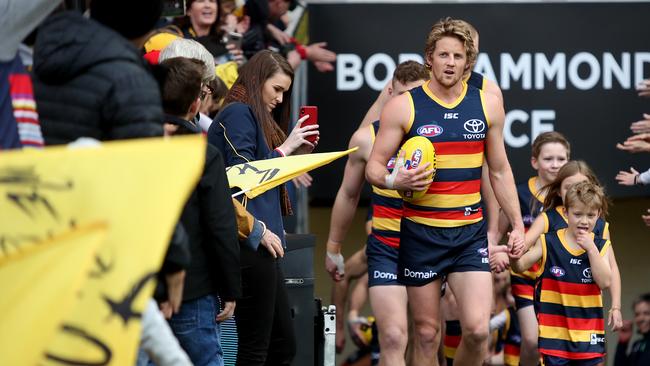 Crows vice-captain Rory Sloane leads the Crows out against North Melbourne at Adelaide Oval. Pictrure: Kelly Barnes/AAP