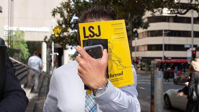 Cuoco covers his face with a cope of the Law Society Journal. Picture: Bianca De Marchi