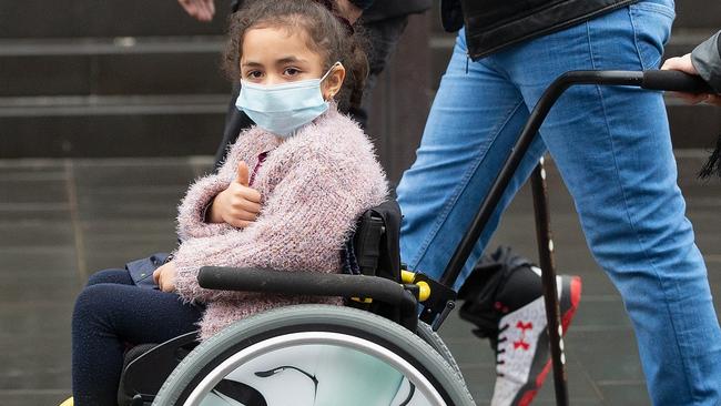 Massacre survivor Alen Alsati, 5, gives a thumbs-up as she arrives at the High Court in Christchurch. Picture: AAP