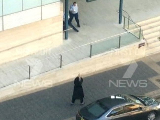 The teen terrorist who shot and killed Curtis Cheng aims his weapon at a police officer in Parramatta. Picture: Channel 7