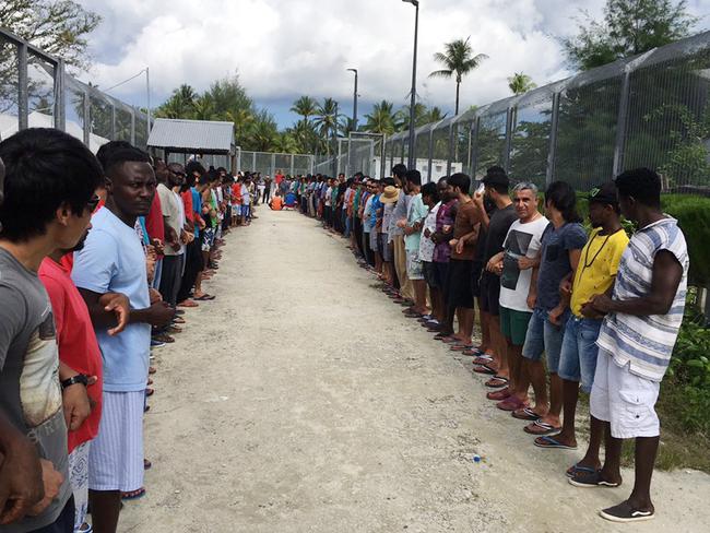 Refugees at Manus Island detention centre link hands in solidarity ahead of the centre's closure. Picture: AAP Image
