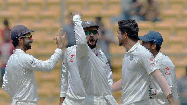 Indian bowler Umesh Yadav celebrates with captain Virat Kohli after the dismissal of Australian captain Steve Smith.