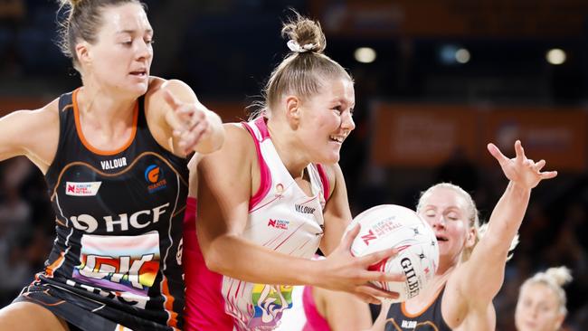 Lucy Austin of the Thunderbirds (C) gains possession despite the close attention of Giants Lauren Moore (L) and April Brandley (R).