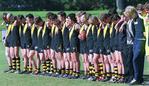 Glenelg under-17 footballers observe a minute's silence in memory of Chris Buss during a match at Elizabeth after his death in July, 2003.