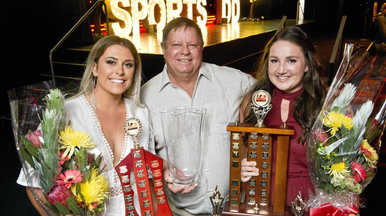 SPORT STARS: Coach Graham Pitt (centre) congratulates his athletes Ellie Bowyer (left) and Lara Nielsen on their award wins last year. Picture: Nev Madsen