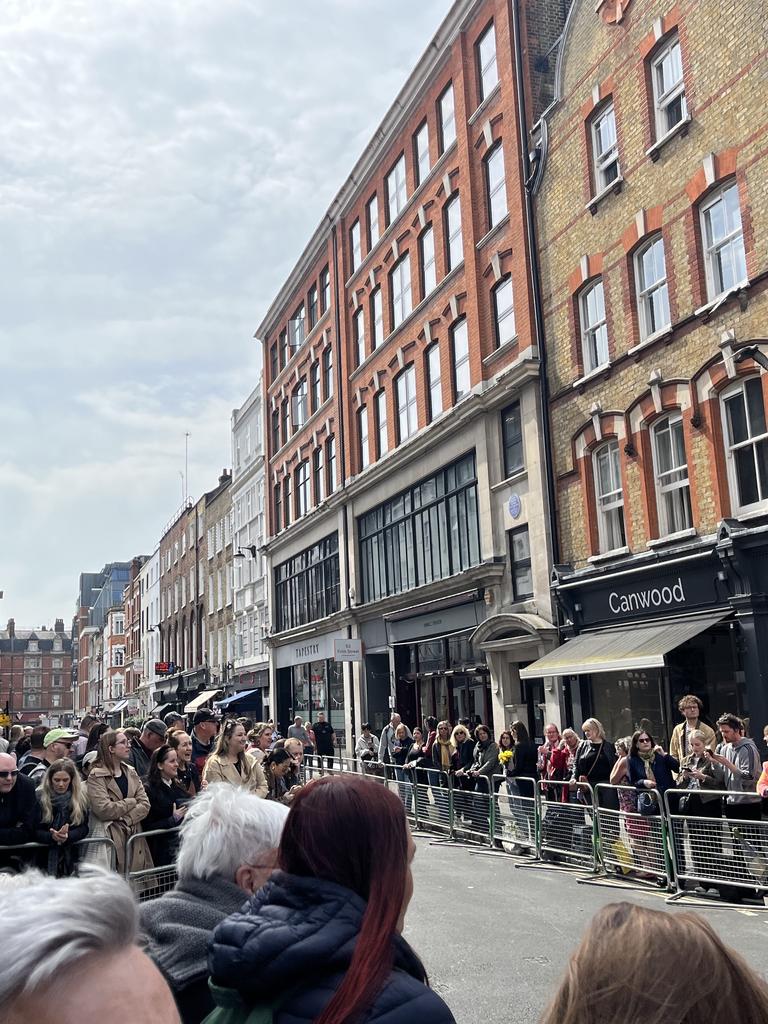 Fans swarm along barricades for William and Kate's surprise walkabout in Soho, London.