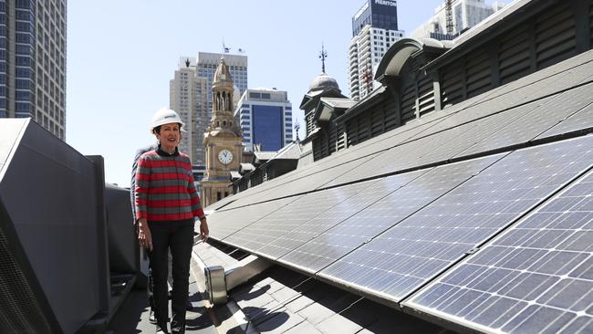 Sydney Lord Mayor Clover Moore stands by solar panels on the roof of Town Hall in October. Picture: Dylan Robinson